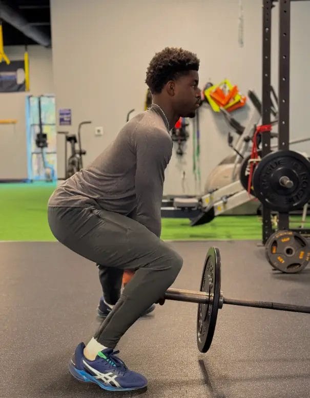 Teen performing training with barbell at Athletic Performance Development